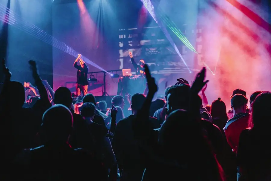 DJ performing behind decks under coloured lights